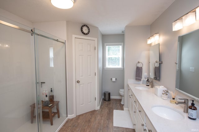 44 Fairfieldview Ct, Lafayette, IN 47905 - bathroom with a shower stall, double vanity, and wood finished floors