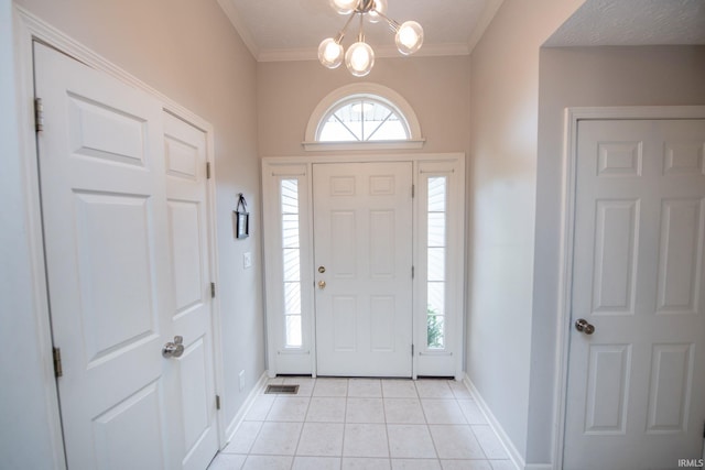 44 Fairfieldview Ct, Lafayette, IN 47905 - entryway with light tile patterned floors, a chandelier, and ornamental molding