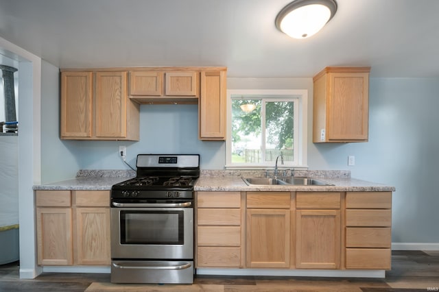 32 W Main St, Redkey, IN 47373 - kitchen with stainless steel gas stove, light brown cabinetry, light countertops, and dark wood finished floors