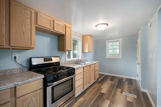 32 W Main St, Redkey, IN 47373 - kitchen featuring stainless steel range with gas stovetop, light brown cabinetry, dark wood finished floors, and light countertops
