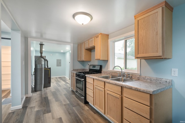 32 W Main St, Redkey, IN 47373 - kitchen with gas stove, light brown cabinetry, dark wood finished floors, and light countertops