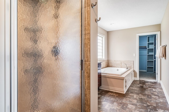 625 Perolla Dr, Fort Wayne, IN 46845 - bathroom featuring a shower stall, a garden tub, and a walk in closet