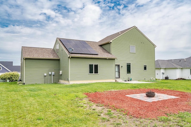 625 Perolla Dr, Fort Wayne, IN 46845 - rear view of property with solar panels, a fire pit, a patio, and a yard