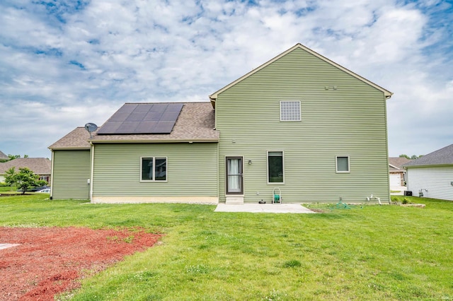 625 Perolla Dr, Fort Wayne, IN 46845 - rear view of property featuring a patio area, a lawn, and roof mounted solar panels