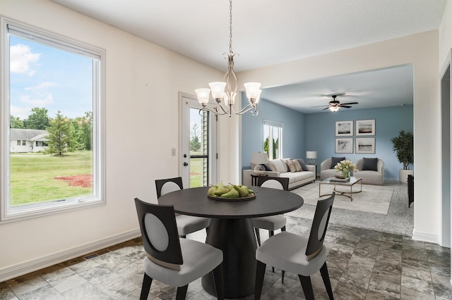 625 Perolla Dr, Fort Wayne, IN 46845 - dining room with a chandelier, a ceiling fan, and dark stone finish flooring