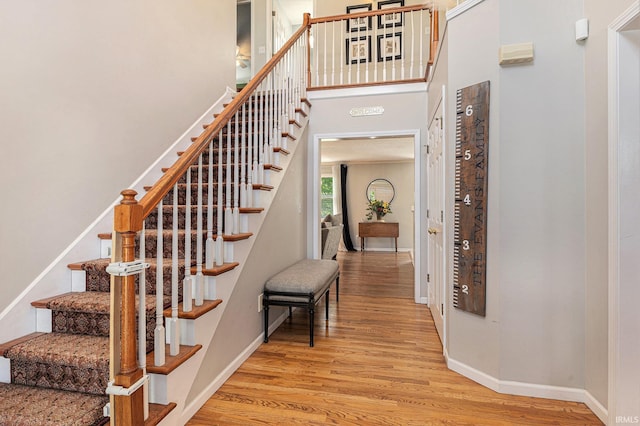 53135 W Cedar Lake Dr, Granger, IN 46530 - stairway featuring wood finished floors and a towering ceiling