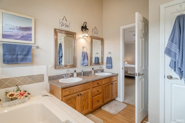 2007 Kingfisher Dr, Lafayette, IN 47909 - ensuite bathroom featuring double vanity, a bath, and wood finished floors