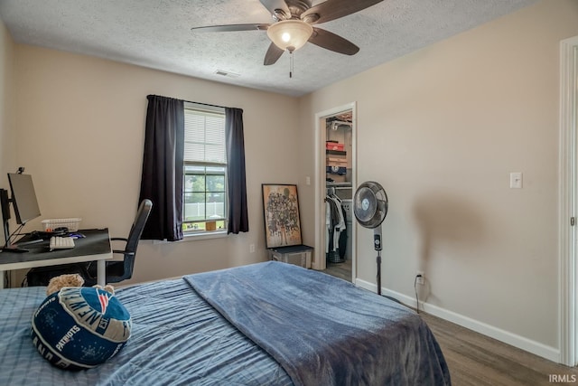 2007 Kingfisher Dr, Lafayette, IN 47909 - bedroom with a textured ceiling, wood finished floors, a walk in closet, and ceiling fan