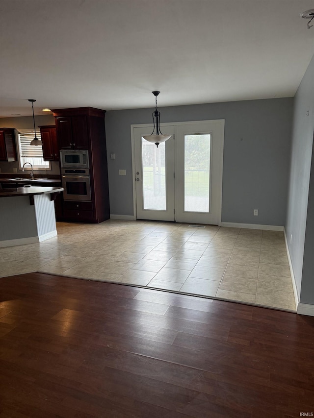 5450 Fox Chase Ct, Boonville, IN 47601 - kitchen with stainless steel appliances, healthy amount of natural light, dark countertops, and light tile patterned floors
