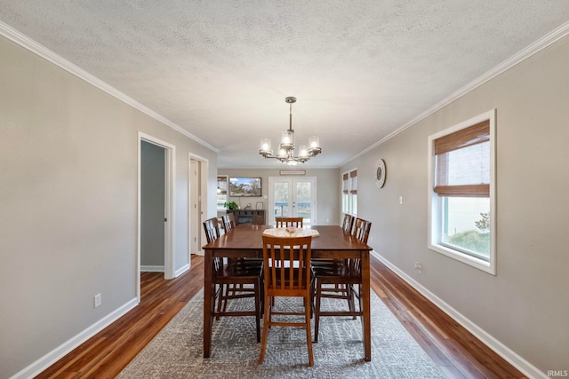 2770 N Baers Ct, Monticello, IN 47960 - dining space featuring dark wood finished floors, healthy amount of natural light, a chandelier, a textured ceiling, and crown molding