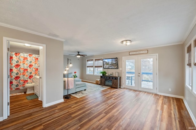 2770 N Baers Ct, Monticello, IN 47960 - living area with wood finished floors, ornamental molding, a ceiling fan, and french doors