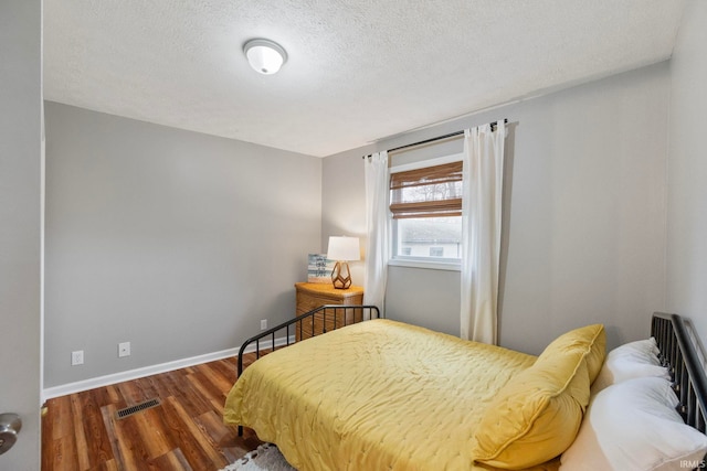 2770 N Baers Ct, Monticello, IN 47960 - bedroom with wood finished floors and a textured ceiling