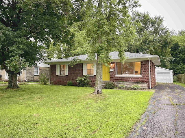 901 N Alvord Blvd, Evansville, IN 47711 - view of front of property with an outbuilding, a front lawn, a detached garage, and brick siding