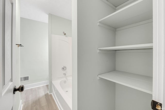 1409 Oakland St, Fort Wayne, IN 46808 - bathroom featuring wood finished floors and tub / shower combination
