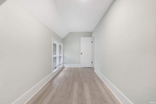 1409 Oakland St, Fort Wayne, IN 46808 - empty room with light wood-style flooring and vaulted ceiling