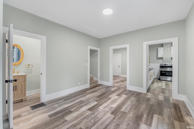 1409 Oakland St, Fort Wayne, IN 46808 - unfurnished bedroom with light wood finished floors and ensuite bathroom