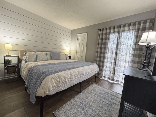 9324 S Lake Ridge Dr Unit 60, Bloomington, IN 47401 - bedroom featuring wood finished floors, wood walls, and a textured ceiling