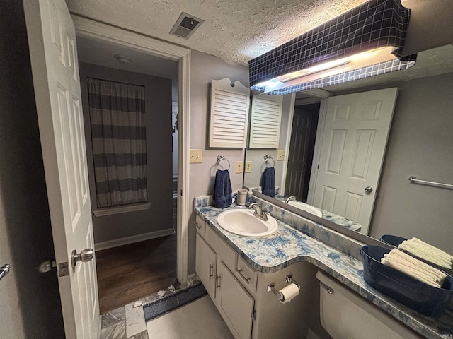 9324 S Lake Ridge Dr Unit 60, Bloomington, IN 47401 - bathroom featuring vanity, a textured ceiling, and wood finished floors