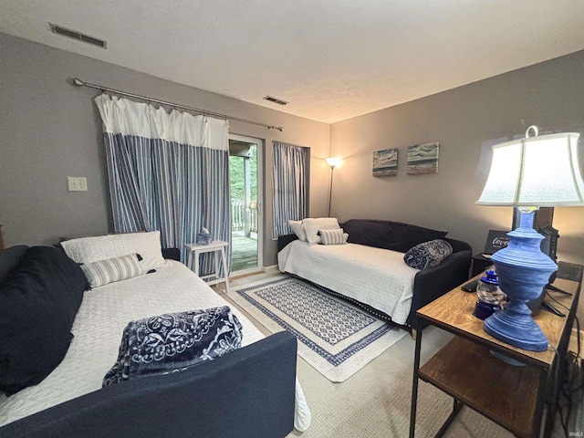9324 S Lake Ridge Dr Unit 60, Bloomington, IN 47401 - bedroom with access to exterior and wood finished floors