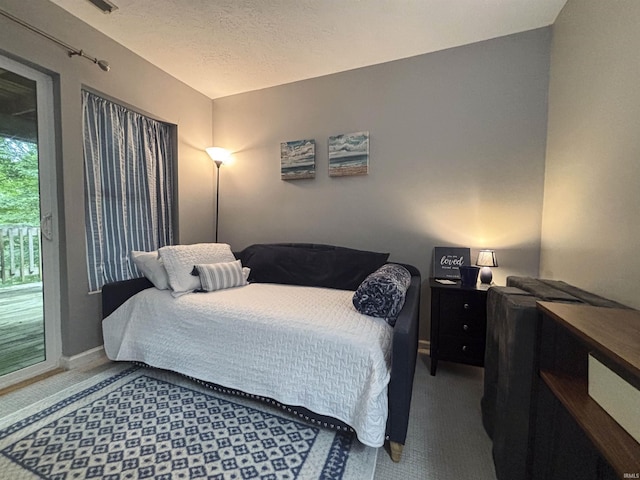 9324 S Lake Ridge Dr Unit 60, Bloomington, IN 47401 - bedroom with carpet floors, access to outside, and a textured ceiling