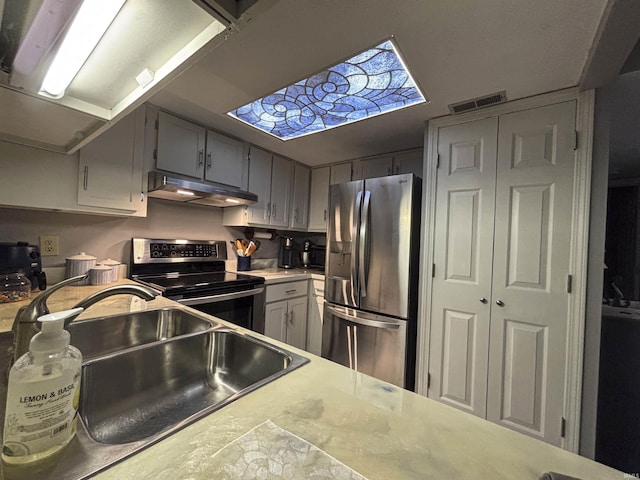 9324 S Lake Ridge Dr Unit 60, Bloomington, IN 47401 - kitchen with range with electric stovetop, stainless steel fridge with ice dispenser, under cabinet range hood, and light countertops