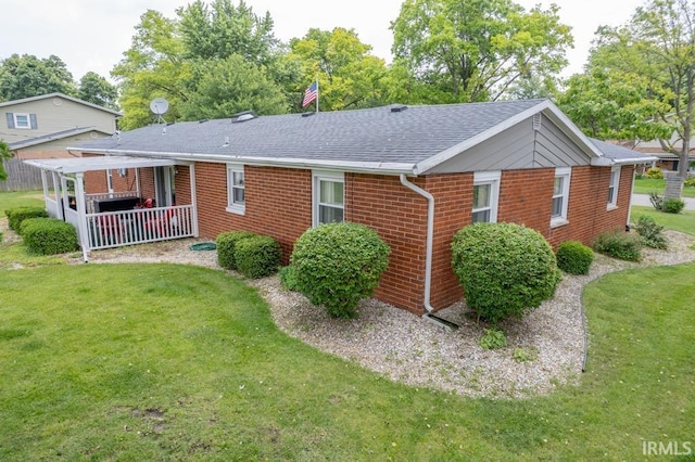 401 Meadow Ln, Hartford City, IN 47348 - view of front of property featuring brick siding, a front yard, and a shingled roof