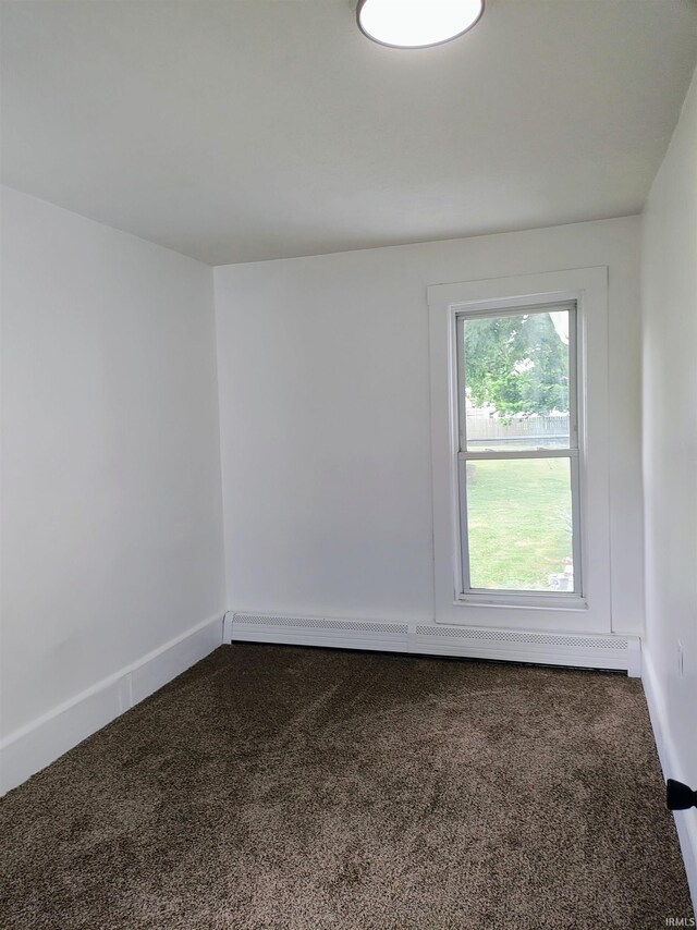 607 W 4th St, North Manchester, IN 46962 - empty room with carpet flooring and a baseboard heating unit