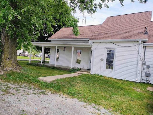 607 W 4th St, North Manchester, IN 46962 - view of front of property featuring a porch, a front yard, and a shingled roof