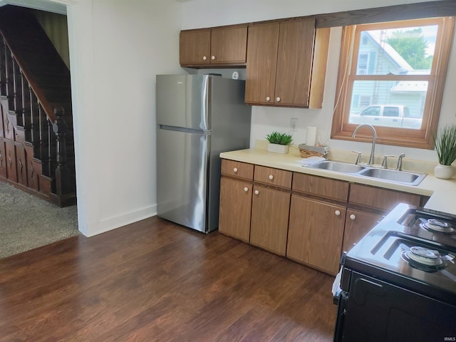 607 W 4th St, North Manchester, IN 46962 - kitchen featuring freestanding refrigerator, range with electric cooktop, dark wood-style flooring, light countertops, and brown cabinetry