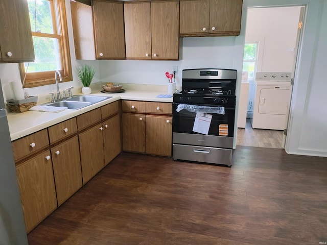 607 W 4th St, North Manchester, IN 46962 - kitchen with stainless steel range with gas stovetop, dark wood-type flooring, light countertops, and washer and dryer