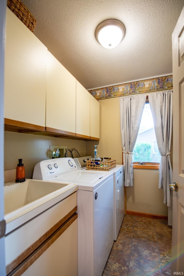 22885 Stonebrier Dr, Elkhart, IN 46514 - laundry area with separate washer and dryer, cabinet space, stone finish flooring, and a textured ceiling