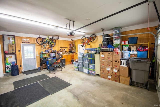 22885 Stonebrier Dr, Elkhart, IN 46514 - garage with wooden walls and a garage door opener