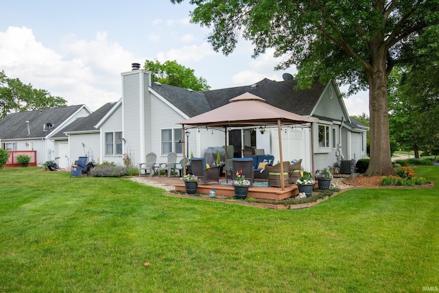 22885 Stonebrier Dr, Elkhart, IN 46514 - back of property with a gazebo, a yard, a deck, a chimney, and outdoor lounge area
