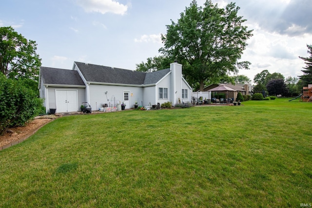 22885 Stonebrier Dr, Elkhart, IN 46514 - view of side of property featuring a gazebo, a playground, a chimney, a yard, and a shingled roof