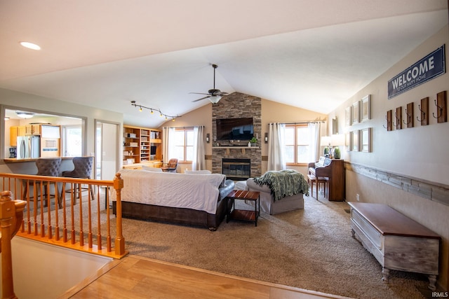 22885 Stonebrier Dr, Elkhart, IN 46514 - living area with ceiling fan, a stone fireplace, lofted ceiling, and wood finished floors