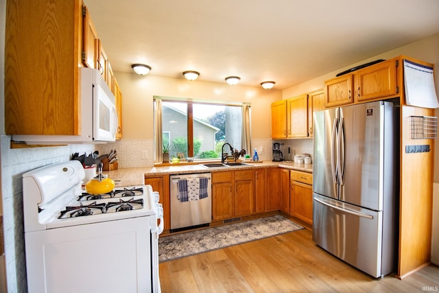 22885 Stonebrier Dr, Elkhart, IN 46514 - kitchen with appliances with stainless steel finishes, light wood-style floors, light countertops, and decorative backsplash