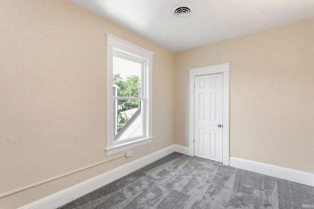 1009 N Adams St, South Bend, IN 46628 - carpeted empty room with baseboards