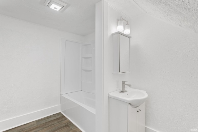 1009 N Adams St, South Bend, IN 46628 - bathroom with vanity, wood finished floors, and bathing tub / shower combination