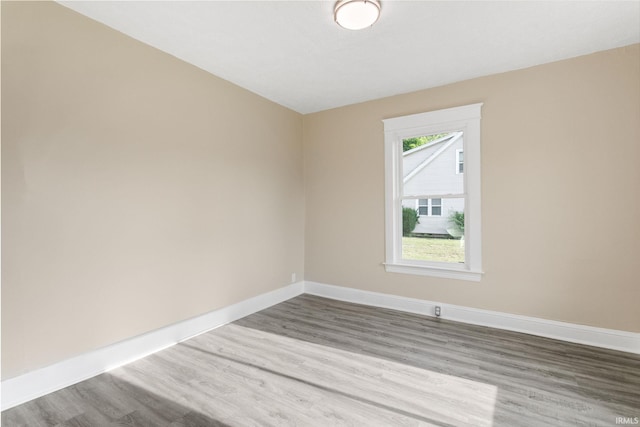 1009 N Adams St, South Bend, IN 46628 - unfurnished room featuring wood finished floors and baseboards