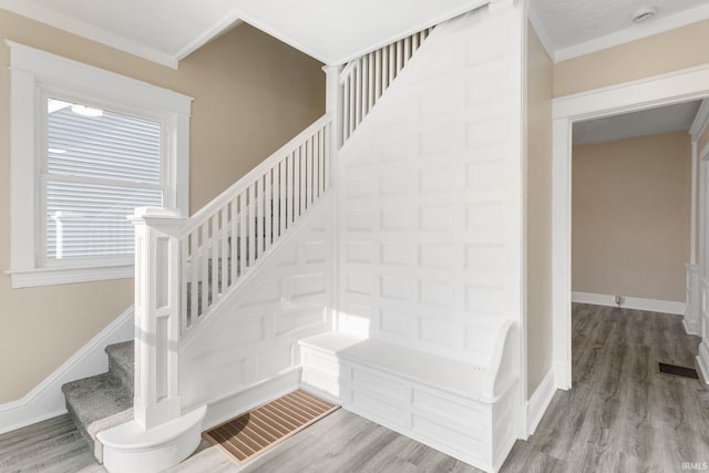 1009 N Adams St, South Bend, IN 46628 - stairway featuring wood finished floors and ornamental molding