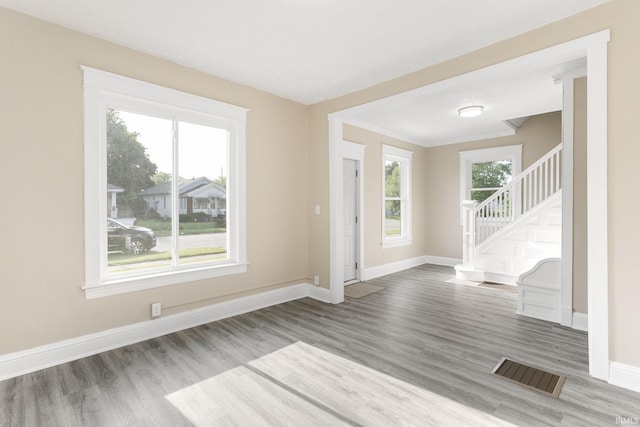 1009 N Adams St, South Bend, IN 46628 - empty room featuring wood finished floors and stairway