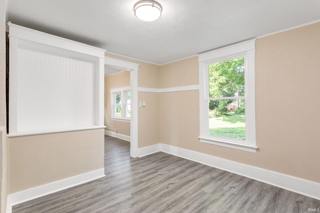 1009 N Adams St, South Bend, IN 46628 - spare room featuring wood finished floors and baseboards