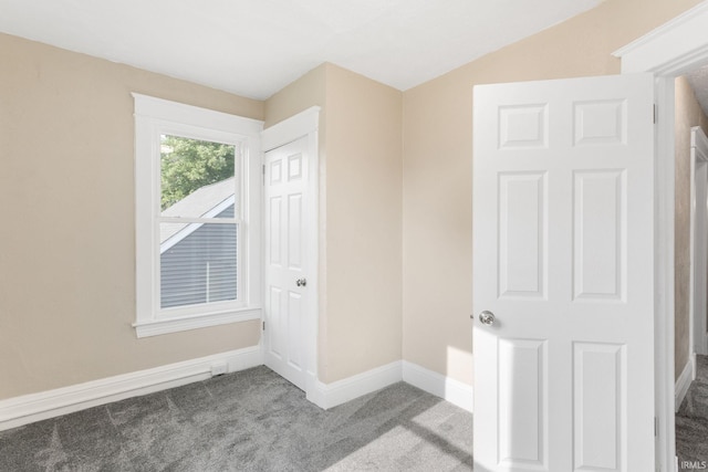 1009 N Adams St, South Bend, IN 46628 - unfurnished bedroom with carpet and lofted ceiling