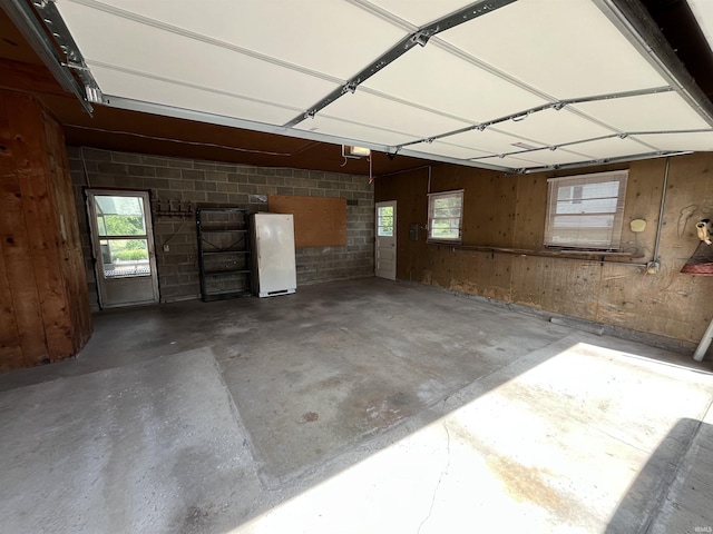 2127 Flora Dr, Peru, IN 46970 - garage featuring freestanding refrigerator and a garage door opener