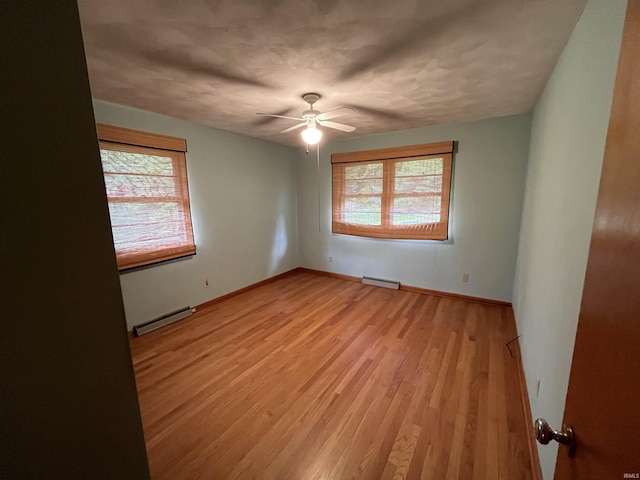 2127 Flora Dr, Peru, IN 46970 - empty room with a baseboard heating unit, light wood-type flooring, and a ceiling fan