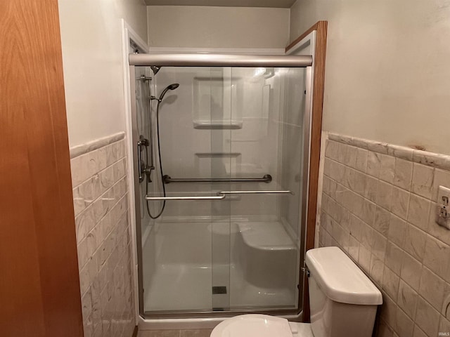 2127 Flora Dr, Peru, IN 46970 - full bath featuring tile walls, a shower stall, and a wainscoted wall