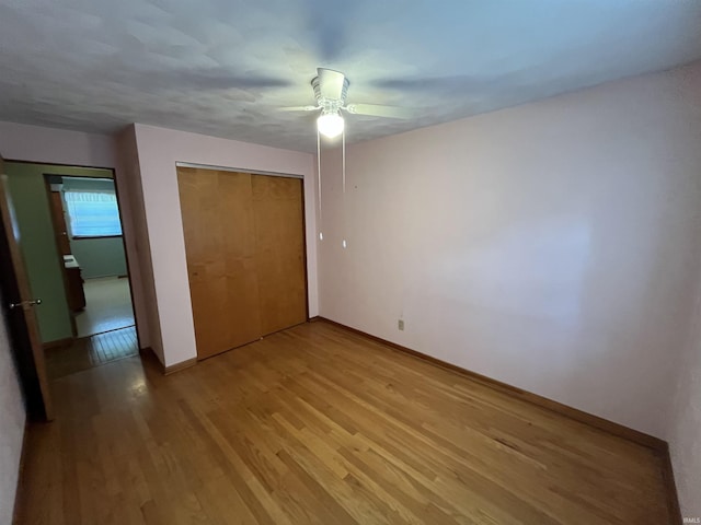 2127 Flora Dr, Peru, IN 46970 - unfurnished bedroom featuring light wood-style floors, a closet, and a ceiling fan