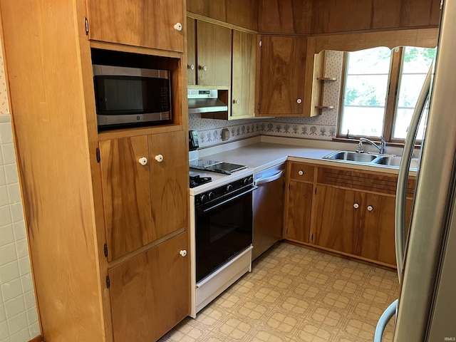 2127 Flora Dr, Peru, IN 46970 - kitchen with appliances with stainless steel finishes, range hood, light flooring, light countertops, and open shelves