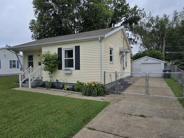 1506 Cass Ave, Evansville, IN 47714 - view of front facade with driveway, a garage, an outbuilding, and a gate