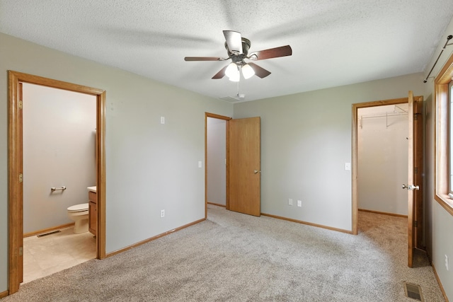 5130 Windy Knoll Ct, Fort Wayne, IN 46809 - unfurnished bedroom with a spacious closet, ensuite bathroom, carpet floors, a closet, and a ceiling fan